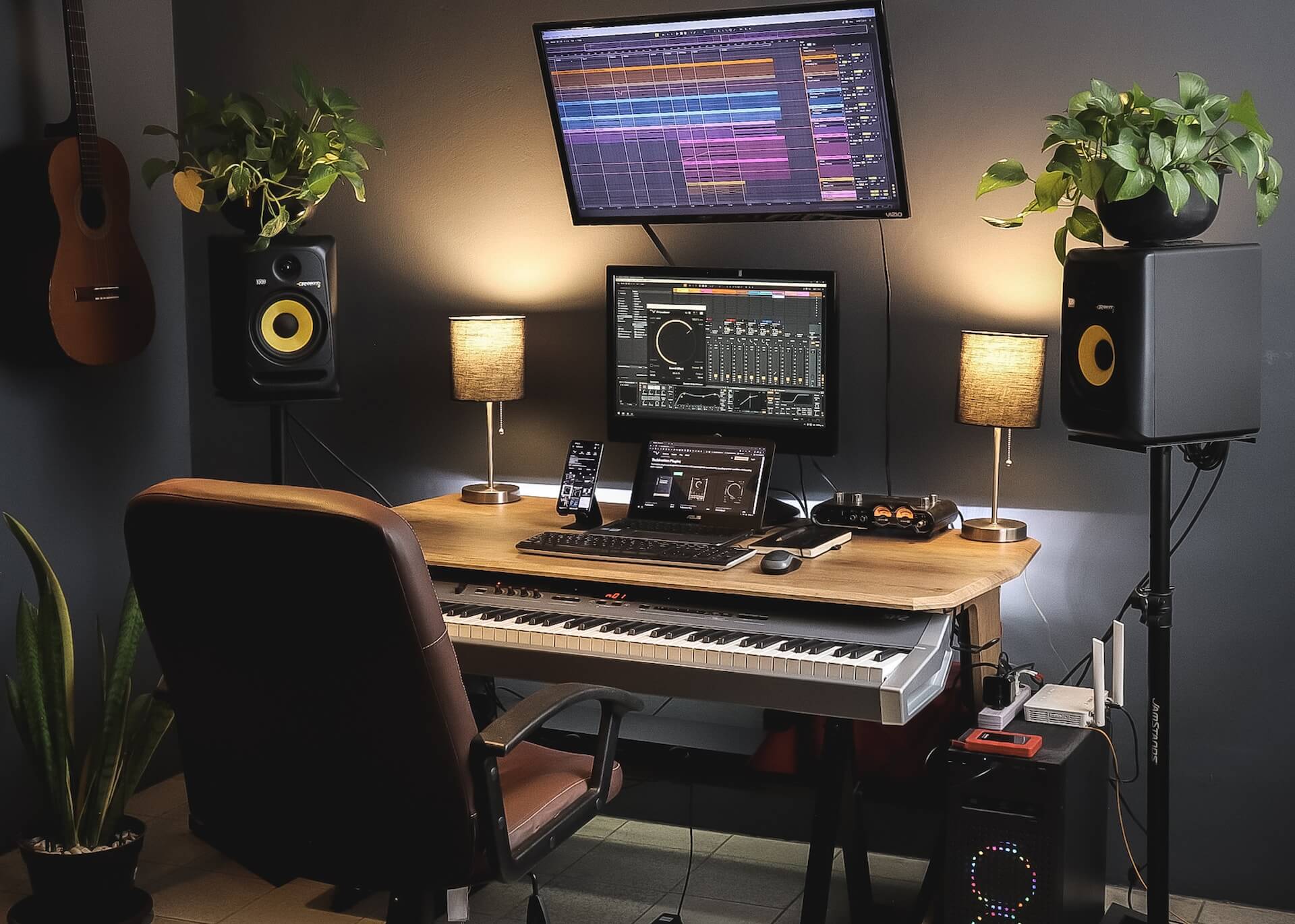 Electrical computer with illuminated lamp on a desk. Cable wiring around the table.